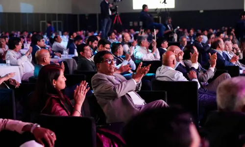 Conference delegates applauding speaker presentation