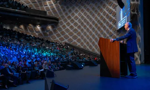 ISPRM World Congress speaker on stage facing theatre of delegates