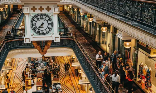 Small group admire the detailed interior of Queen Victoria Building during a guided architecture tour